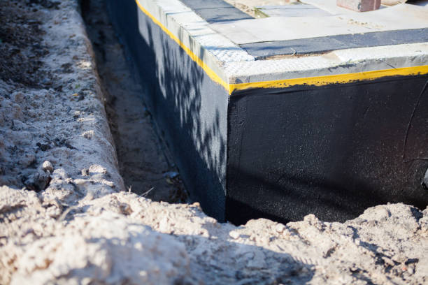 Professional Basement Waterproofing technician working in Lumberton, NC